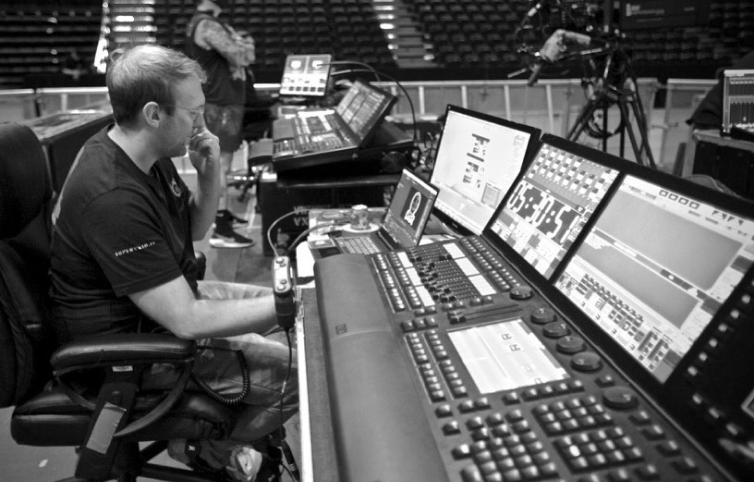 Drew working the lighting console at a concert